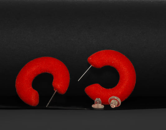 Red flocked c-shaped hoop earrings.